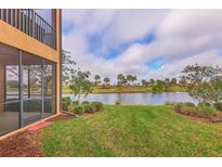 View of a backyard with a pond and golf course at 10796 Tarflower Dr # 102, Venice, FL 34293