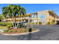Attractive condo building with palm trees and ample parking at 2155 Wood St # B17, Sarasota, FL 34237