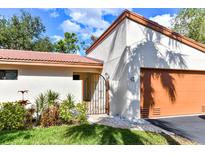 Inviting exterior with a charming gate and lush landscaping at 3404 Falcon Pl, Bradenton, FL 34210