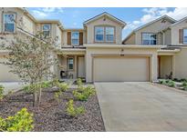 Two-story townhome with attached garage and landscaped front yard at 5509 Coachwood Cv, Bradenton, FL 34211