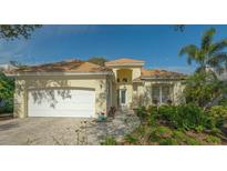 Single-story house with a white garage door and landscaped front yard at 6525 Berkshire Pl, University Park, FL 34201