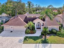 Spacious home with a large driveway and lush landscaping at 8365 Shadow Pine Way, Sarasota, FL 34238