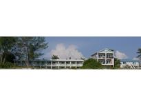 Beachfront property showcasing two buildings with balconies and beach access at 2310 Gulf N Dr # 205, Bradenton Beach, FL 34217
