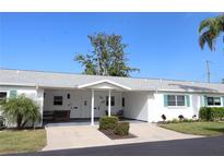 White single story home with carport and landscaped yard at 6100 Coral Way, Bradenton, FL 34207