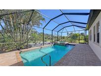 Screened pool and spa with brick pavers and tropical landscaping at 10656 Glencorse Ter, Bradenton, FL 34211