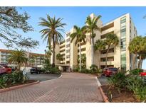 Exterior view of a multi-story building with palm trees and parking at 1510 1St W Ave # 504, Bradenton, FL 34205