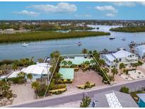 Aerial view of waterfront home with large lot and boat access at 411 S Casey Key Rd, Nokomis, FL 34275