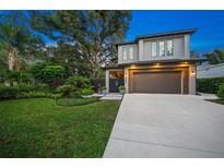 Two-story home with modern facade and landscaped yard at 2124 Wisteria St, Sarasota, FL 34239