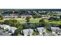 Aerial view of a community with golf course and lake at 5507 Fair Oaks St # 3-C, Bradenton, FL 34203