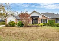 Brick house with a landscaped lawn and a spacious front yard at 6221 28Th E Ave, Bradenton, FL 34208