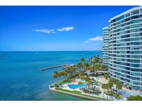 Aerial view of waterfront highrise condo building with pool and marina at 888 Blvd Of The Arts # 1408, Sarasota, FL 34236