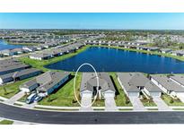 Aerial view of a house and community with lake at 9244 Ballaster Pointe Loop, Parrish, FL 34219