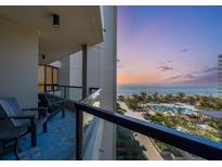 Beachfront balcony with ocean views and seating for two at 1211 Gulf Of Mexico Dr # 403, Longboat Key, FL 34228