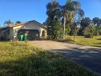 Ranch-style home with attached garage and spacious yard at 1346 Kenmore St, Port Charlotte, FL 33952