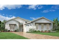Two-story home with light-colored exterior, two-car garage, and landscaping at 17920 Palmiste Dr, Bradenton, FL 34202