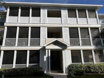 Three-story building exterior with screened balconies and landscaping at 4802 51St W St # 708, Bradenton, FL 34210