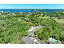 Aerial view of a house nestled in a lush, green landscape, near a body of water at 5104 2Nd E Ave, Palmetto, FL 34221