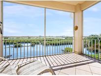 Spacious screened balcony overlooking water and lush landscape at 5440 Eagles Point Cir # 405, Sarasota, FL 34231