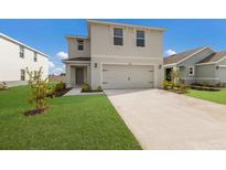 Two-story house with a two-car garage and landscaped lawn at 5846 Silver Moonlight Dr, Palmetto, FL 34221