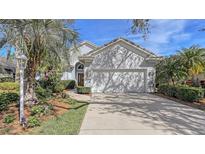 House exterior with landscaped yard and driveway at 7121 Victoria Cir, University Park, FL 34201
