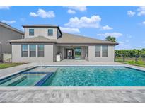 Home with inviting pool and spa, spacious patio, and outdoor kitchen at 9511 Tequila Sunrise Dr, Sarasota, FL 34241