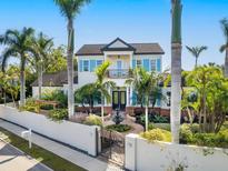 Two-story house with a white exterior, blue shutters, and a fountain in the front yard at 1810 Lincoln Dr, Sarasota, FL 34236