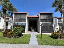 Condo building exterior featuring a walkway and landscaping at 3231 Beneva Rd # 103, Sarasota, FL 34232