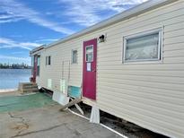 Quaint Waterfront mobile home with a red door at 3710 Gulf Of Mexico Dr # G26, Longboat Key, FL 34228