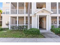 Inviting condo building exterior with covered entryway and lush landscaping at 4802 51St W St # 501, Bradenton, FL 34210