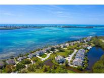 Aerial view of waterfront community with lush landscaping and private docks at 61 Tidy Island Blvd, Bradenton, FL 34210