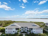 Front view of condo building showcasing waterfront location and architectural details at 1125 Edgewater Cir # 13 Sec 1, Bradenton, FL 34209