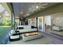Covered patio with fire pit and seating area, overlooking backyard at 1143 Myrtle St, Sarasota, FL 34234