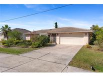 Single-story home with attached garage and landscaped front yard at 339 Rio De Janeiro Ave, Punta Gorda, FL 33983