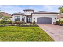 Single-story home with gray garage door and landscaped yard at 4534 Trento Pl, Bradenton, FL 34211
