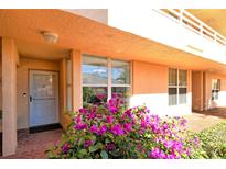 Inviting condo entrance with lush landscaping and brick walkway at 4550 Pinebrook Cir # 105, Bradenton, FL 34209
