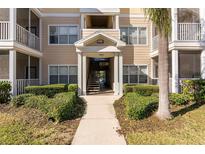 Inviting condo building entrance with landscaping and stairs at 4802 51St W St # 1304, Bradenton, FL 34210
