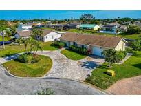 Aerial view of a single-Gathering home with a large driveway and landscaped yard at 5011 Mangrove Point Rd, Bradenton, FL 34210