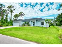 Single-story home with a spacious lawn and attached garage at 5371 Fleming St, Port Charlotte, FL 33981