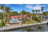Aerial view of waterfront home with private pool and dock at 5376 Shadow Lawn Dr, Sarasota, FL 34242