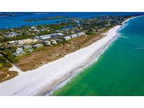 Aerial view of beachfront property with homes and lush landscaping at 6925 Gulf Of Mexico Dr # 24, Longboat Key, FL 34228