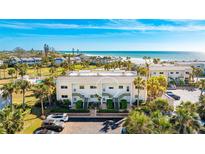 Aerial view of condo community near beach with pool and parking at 7155 Gulf Of Mexico Dr # 22, Longboat Key, FL 34228