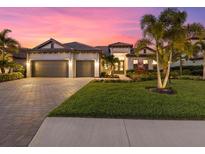 Stunning curb appeal with lush landscaping and a two-car garage at 16203 Tradewind Ter, Lakewood Ranch, FL 34211