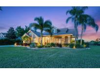 Beautiful two-story home with landscaped yard and palm trees at 22623 Morning Glory Cir, Bradenton, FL 34202