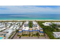 Aerial view of a coastal condo building with oceanfront access at 3810 Gulf Of Mexico Dr # F402, Longboat Key, FL 34228