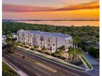 Aerial view of modern building at sunset, near water at 4950 Remington Dr # 403, Sarasota, FL 34234