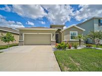 One-story home with a two-car garage and landscaped front yard at 5282 Grove Mill Loop, Bradenton, FL 34211
