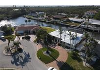 Aerial view of waterfront home with circular driveway and canal access at 5308 Coral Blvd, Bradenton, FL 34210