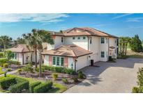 Luxury two-story home with tile roof, and landscaped grounds at 7486 Divot Loop # 7486, Bradenton, FL 34202