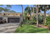Exterior of charming condo with attached garage and lush landscaping at 7938 Pinegrove Ct # 12, Sarasota, FL 34238