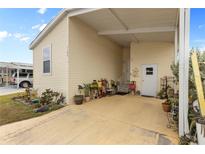 Exterior view of a manufactured home with covered carport and landscaping at 1106 49Th Avenue W Dr, Bradenton, FL 34207